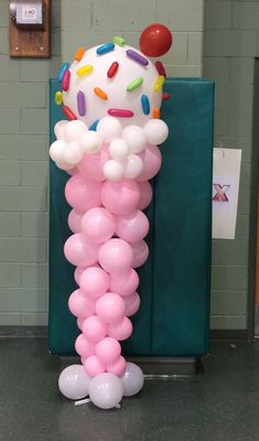 the balloon column is decorated with sprinkles and balloons