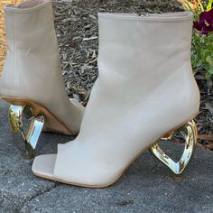 Peep-Toe Ankle Boot Gold Heart-Shaped Heel Vegan Leather True To Size Zipper Pull 3-Inch Heel Cream Glamorous Ankle Boot Heels For Spring, Spring Open Toe Boots With Sculpted Heel, Open Toe Boots With Sculpted Heel For Spring, Interesting Shoes, Marine Outfit, Peep Toe Ankle Boots, Trending Heels, Wardrobe Goals, Fantastic Shoes