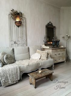 a living room filled with furniture and a mirror on the wall next to a coffee table