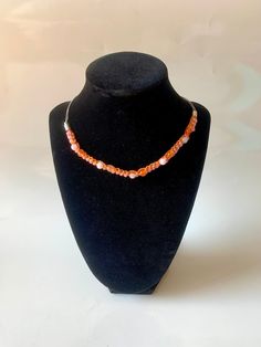 A hand woven crochet choker necklace with gemstones woven in, this choker is perfect for adding a bit of handmade witchy flair to your wardrobe.  Carnelian symbolises bold energy, warmth, and a joy that lingers as much as it empowers and stimulates. It is known for being a stone of courage, endurance, energy, leadership, and motivation. Rose Quartz is a stone of unconditional love and emotional healing. It can boost feelings of peace, calm, and self-love. Festival Natural Stone Beaded Choker Necklace, Adjustable Handmade Orange Necklaces, Handmade Adjustable Orange Necklace, Adjustable Natural Stone Choker Necklace, Bohemian Choker Jewelry With Lobster Clasp, Adjustable Single Strand Crystal Choker Necklace, Adjustable Single Strand Crystal Choker, Handmade Crystal Choker Necklace For Festival, Handmade Spiritual Choker Jewelry