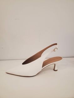 White Pointed Toe slingback in Faux Leather. Pulls on, 50mm covered flared heel. Beige polished sole in faux leather. Info & Care 100% PL 100% faux leather lining Handmade in Italy Size & Fit Whole sizes only, runs slightly narrow. US size 6.5=Size 37, size 7.5 = Size 38, Size 8.5= Size 39, Size 9.5= Size 40 Returns & Exchanges New and unused full-price merchandise returned 14 days after receipt is eligible for refund or exchange. Discounted merchandise is final sale. Black Fringe Dress, Fishtail Parka, Zip Front Dress, Indigo Prints, Cowl Dress, Lace Pants, Black Satin Dress, Cowl Neck Dress, Oversized Tunic