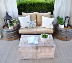 a living room filled with furniture and potted plants on top of a wooden table