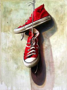 a painting of red shoes hanging from a hook on the side of a white wall