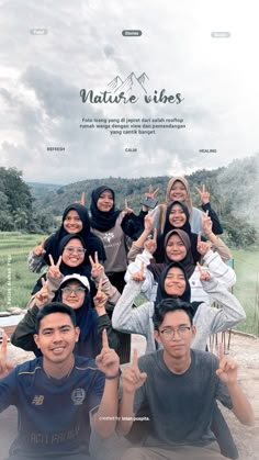 a group of people posing for a photo with their hands in the air and mountains behind them