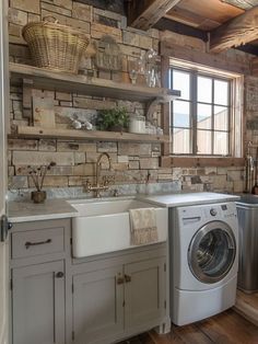 a washer and dryer in a small room with brick walls on the wall