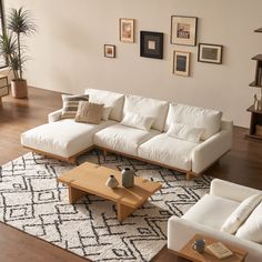 a living room with white couches and wooden tables