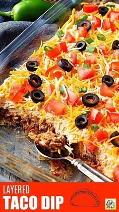 a close up of a tray of food with the words layered taco dip on it