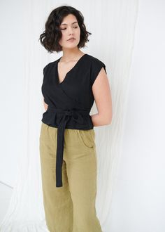 "SIZING & FIT This garment is true to size, and we recommend choosing the size you usually wear. If you want the garment to be loose-fitting, choose a larger size than you usually wear. Before placing an order, check the approximate measurements of the finished garment given below. Model is 5′9″ (175cm) tall with a 97cm/38″ bust, 71cm/28″ waist, 109cm/43″ hip, and she is wearing an L in black. XS Length ± 50cm | 19.7\" Bust ± 92cm | 36.2\" Sleeve length from neckline ± 14.5cm | 5.7\" Sleeve Versatile Black Linen Top, Casual Linen Wrap Top, Black Linen Top For Workwear, Black Linen Tops For Workwear, Casual Black Wrap Top For Spring, Linen Sleeveless Blouse For Work, Sleeveless Linen Top For Work, Sleeveless Wrap Top, Making Stuff