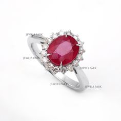 a ring with an oval shaped ruby stone surrounded by smaller round diamonds and labeled names