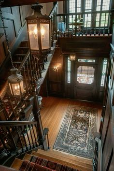 an overhead view of a staircase with two lamps on each side and a rug in the middle