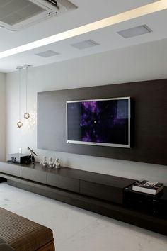 a large flat screen tv mounted to the side of a wall in a living room