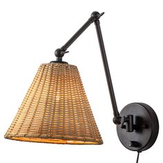 a wall light with a woven shade on the side and an iron rod attached to it