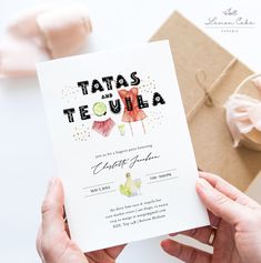 a person holding up a card that says tatas tequila with an image of a dress on it