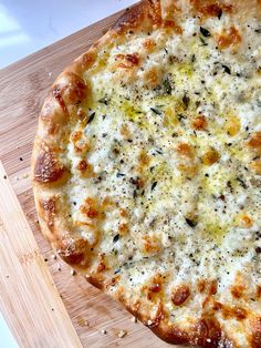 a pizza sitting on top of a wooden cutting board