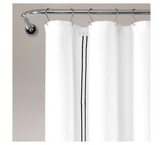 a white shower curtain with black lines on it's side hanging from a metal rod