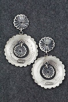 These sterling silver earrings were made by Navajo silversmith Eugene Charley. The backs are signed Eugene Charley and stamped sterling.Length: 3 1/4"Width: 2 1/8"Free shipping on all orders! We ship with USPS and always include tracking. All orders ship within a day of payment.Returns are accepted up to 30 days after you receive your order. Just send us a message. Our shop offers cash back or store credit. The item must be returned in new condition. Sterling Silver Concho Dangle Jewelry, Southwestern Sterling Silver Concho Jewelry, Spring Sale, Sterling Silver Earrings, Silver Earrings, Stamp, Sterling Silver, Silver, Free Shipping