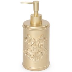 a gold colored soap dispenser with an emblem on the front and bottom