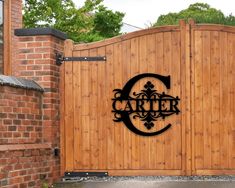 a wooden gate with the letter c on it