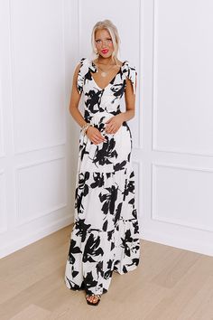 - Get ready for garden party season with this gorgeous maxi! Its abstract floral print and open back put a modern twist on classic style. - Let your chic style take center stage with this charming dress. - Black and ivory colored material with an abstract floral print - A built-in lining ending above the knee - Tie closure straps - A v-cut neckline - An open back with a tie accent - A waistline with an elastic banded back and back zip closure - A flowy yet flattering silhouette that ends in a ma Tea Garden Party, Party Maxi Dress, Abstract Floral Print, Tea Garden, Maxi Dress Party, V Cut, V Cuts, Center Stage, Ivory Color