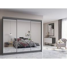 an image of a bedroom with mirrored closet doors in the middle and a bed on the other side