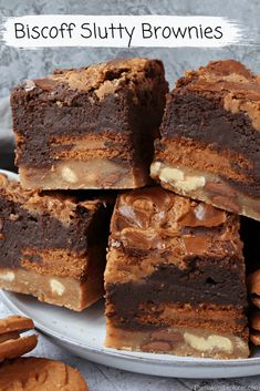 a white plate topped with brownies cut in half and stacked on top of each other