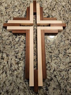 a wooden cross sitting on top of a counter