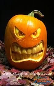 a carved pumpkin with an evil face on it