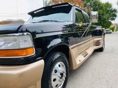 a black and tan truck parked on the street