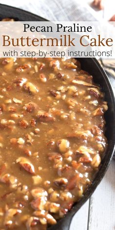 a skillet filled with buttermik cake on top of a wooden table next to nuts