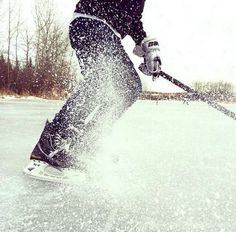 a man riding skis down the side of a snow covered slope on top of ice