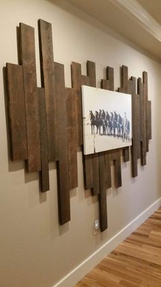 a wooden wall hanging on the side of a white wall