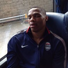 a man sitting on a bus with his eyes closed