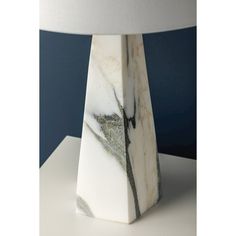 a marble lamp with a white shade on it