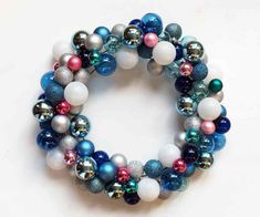 a close up of a bracelet made out of christmas baubles and other ornaments