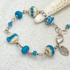 Bohemian Blue Czech Glass Bracelets, Artisan Blue Bracelets For The Beach, Artisan Blue Beaded Bracelets For Beach, Artisan Blue Beaded Bracelets As A Gift, Nickel Free Bohemian Blue Beaded Bracelets, Unique Turquoise Czech Glass Beaded Bracelets, Artisan Blue Beaded Bracelets For Gift, Nickel Free Blue Bohemian Beaded Bracelets, Blue Wire Wrapped Bracelets With Round Beads