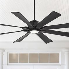 a ceiling fan that is hanging from the ceiling in front of a white wall and door