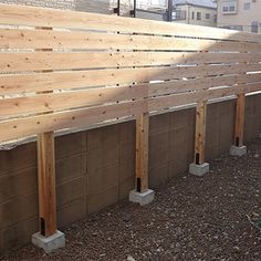 a row of wooden benches sitting next to each other on top of a dirt field