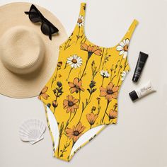 This yellow boho chic one-piece swimsuit features the beauty of meadow flowers. Enjoy the smooth fabric and the flattering design, and show it off by the sea or pool! Please check the sizing chart between the listing photos. * 82% Polyester, 18% Spandex * Fabric weight: 6.78 oz/yd² (230 g/m weight may vary by 5% * Chlorine-resistant fabric * Cheeky fit with a scoop neckline and a low scoop back * Zig-zag stitching * Double-layer front  * Four-way stretch material stretches and recovers on the cr Bohemian Swimsuit, Swimsuit Yellow, Yellow One Piece, Chic Swimsuit, Floral Swimwear, Yellow Swimsuits, Retro Swimsuit, Romantic Outfit, Floral Collection