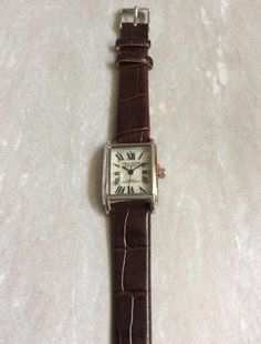 Vellacio silver women's watch, having a rectangle mother of pearl dial, displaying easy to read roman numeral hours, all on a brown leather strap band! this is a unused still new vintage watch, ready to keep you up with accurate time! measurements: bezel/case 1 1/8" x 3/4" rectangle, dial 3/4" x 5/8" rectangle, band width 1/2" and fits perfectly a 5 1/2" up to a 7 1/2". we ship fast, the next business day, for a quick delivery to you! may you have a wonderful time shopping, best wishes! Rectangle Watch Women, Rectangle Watch, Silver Watches Women, A Rectangle, Roman Numeral, Brown Leather Strap, Women's Watch, Roman Numerals, Quick Delivery