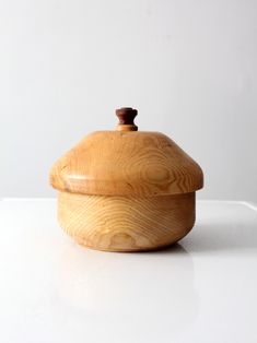 a wooden container sitting on top of a white table