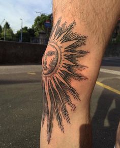 a person with a sun tattoo on their leg