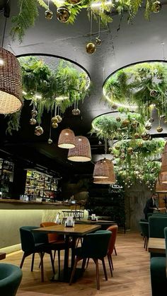 the interior of a restaurant with plants hanging from the ceiling