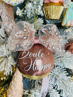 a minnie mouse ornament hanging from the side of a christmas tree with decorations around it