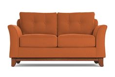 an orange couch sitting on top of a white floor