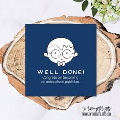 a blue card with the words well done on it next to a tree stump and flowers