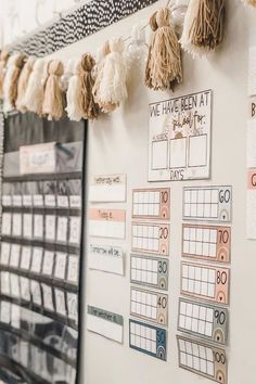 a bulletin board with tassels hanging on it and the words, 100 days at school