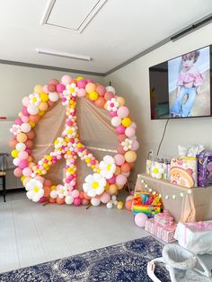 a peace sign made out of balloons in a room