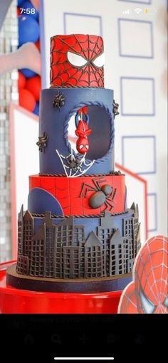 a spiderman themed birthday cake is shown on the phone screen, with balloons in the background