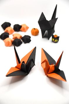 origami bats and pumpkins on a white surface