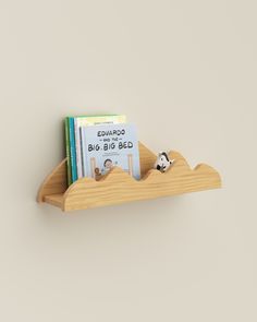 a wooden shelf with two books on it